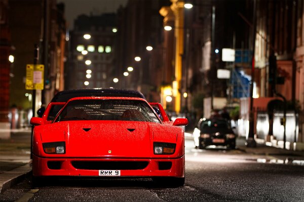 Red Ferrari car on the street background