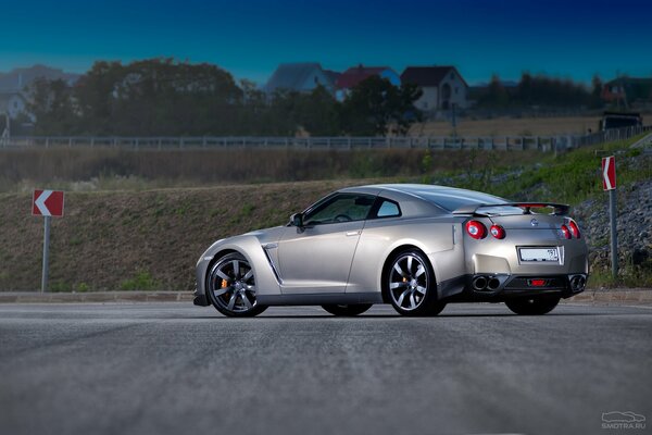 A beautiful gray-colored car is standing on the road