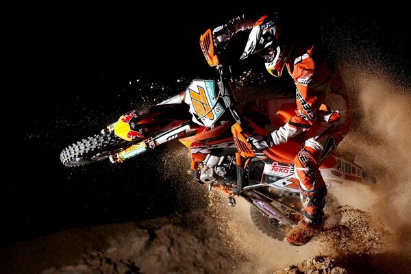 Motorcyclist in the dust at a motocross competition