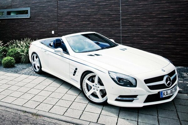 Weißes Mercedes-Benz-Auto vor dem Hintergrund eines Luxus-Hauses