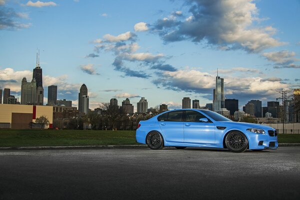 The extraordinary blue color of the BMW against the background of the urban jungle