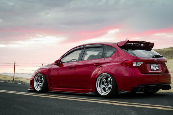 Subaru red car on the road 