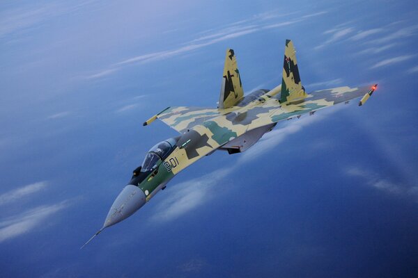 Su-35 fighter at altitude in the blue sky