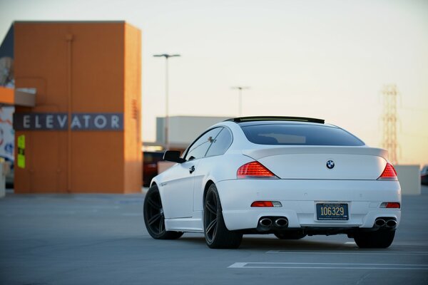 White BMW in the parking lot. Rear view