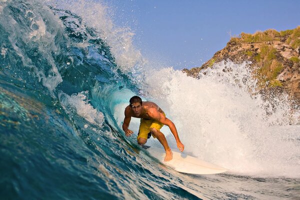 A surfer on the wave of a not calm ocean