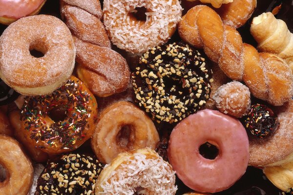 Sweet pastries. Donuts with different powders