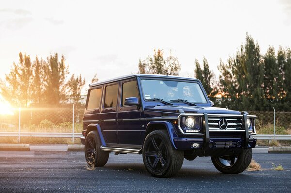 Blue Mercedes SUV at dawn