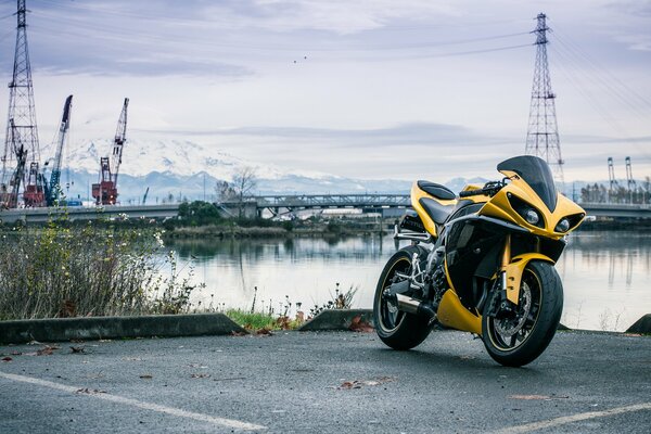 Yellow motorcycle on the river bank