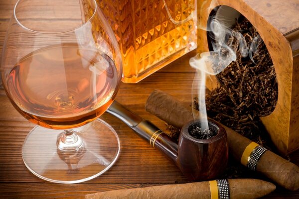 Smoking pipe with cigars and cognac