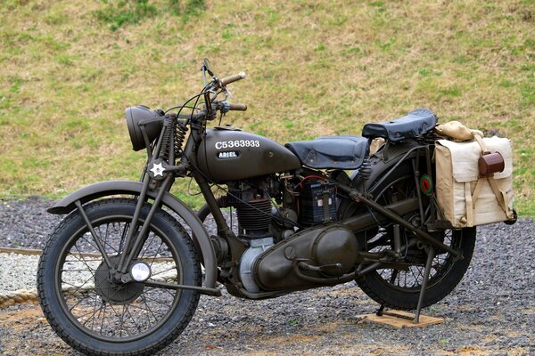 Black British motorcycle on the road in the field