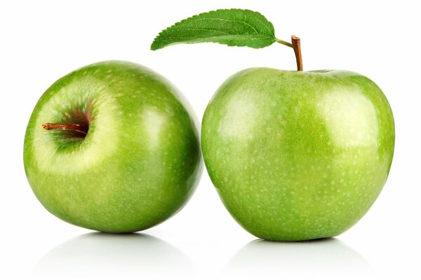 On a white sheet, on a white background, a bright apple