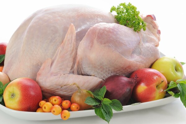 Chicken with vegetables and fruits on the table