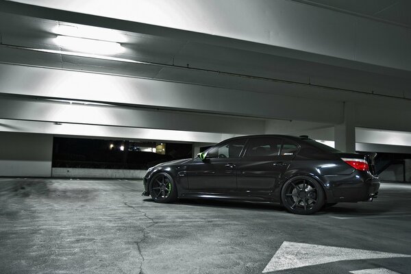 Black BMW in the night parking lot