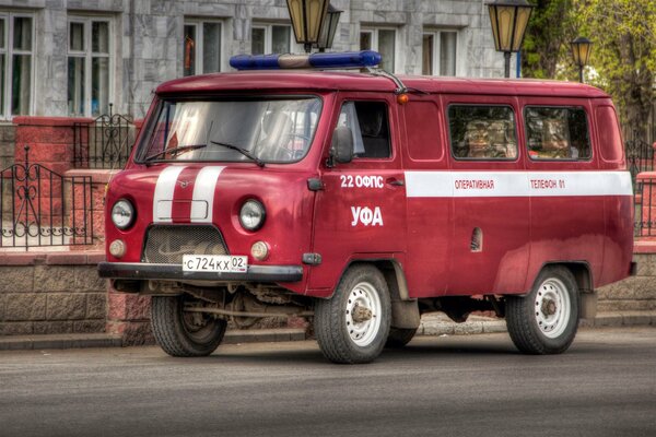 Red UAZ fireman on the street in the city