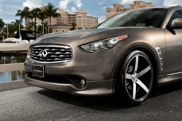 Infiniti fx car stands at the pier against the background of palm trees