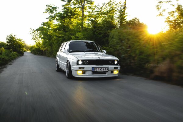 White bmw e30 car on sunset background