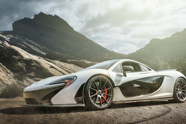 White mclaren supercar on the background of mountains