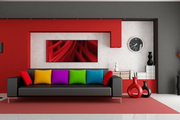 Duża czarna sofa w pokoju z czerwonymi akcentami