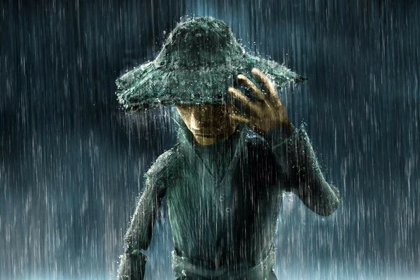 A wooden puppet in a hat stands in the rain