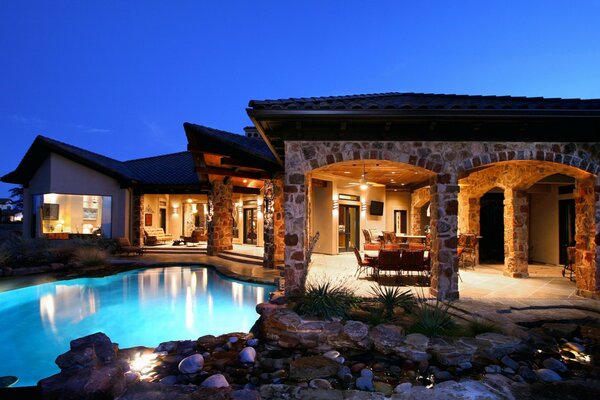 A chic mansion with a blue pool