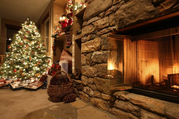 Christmas tree by the burning fireplace