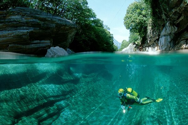 A diver in a lake in the mountains clean water