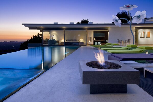 Azure sky on the background of a house with a swimming pool