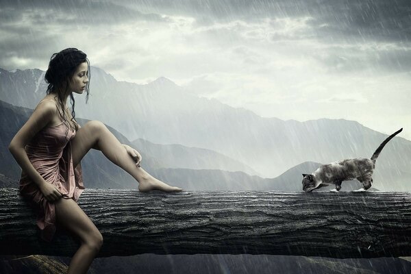 Chica con gato en un árbol bajo la lluvia