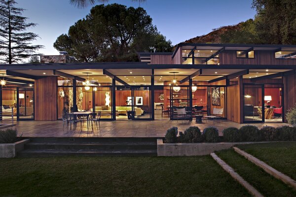 House with panoramic windows lighting from the outside