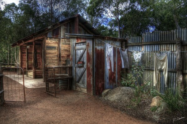 A rustic house with clothes hanging on a rope to dry