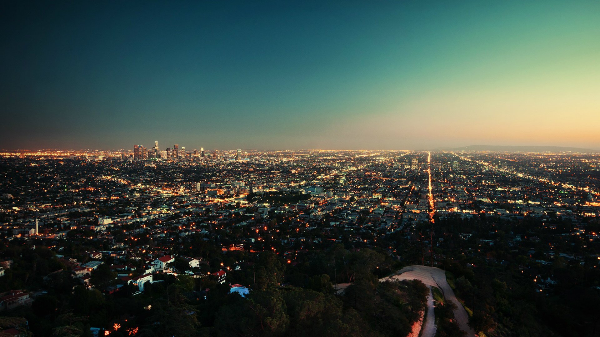 ciudad noche luces horizonte desde arriba puesta de sol