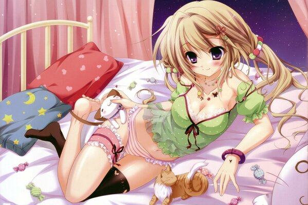 The girl is lying on the bed, sweets are scattered around