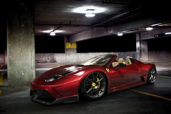 Red Ferrari spider at night multi-level parking