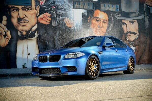 Bmw f10 on the road near graffiti godfather