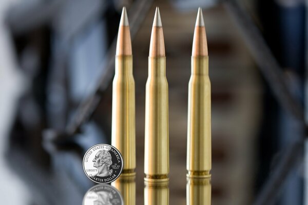 Macro shooting of a coin against a background of bullets