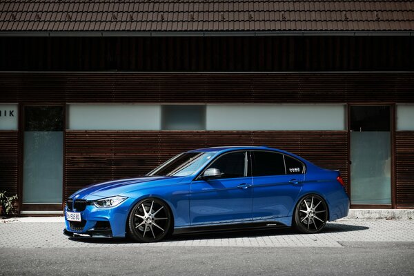 Shiny blue bmw near the house