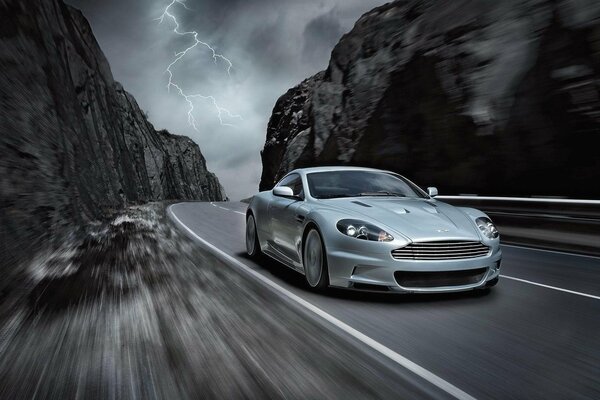 Beautiful car on the background of mountains in a thunderstorm