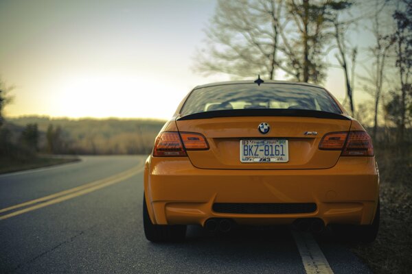 Orange BMW on the evening highway