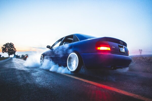 Smoke from under the wheels of an audi sports car