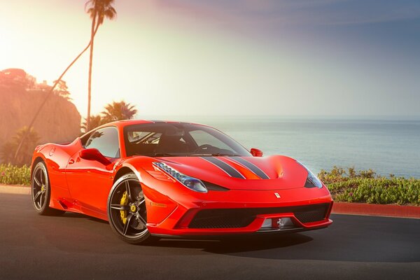 Red Ferrari on the background of the sea and clouds