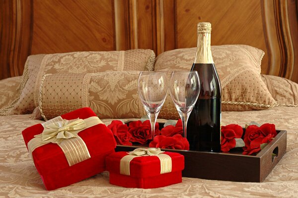 Gifts in red packaging and champagne