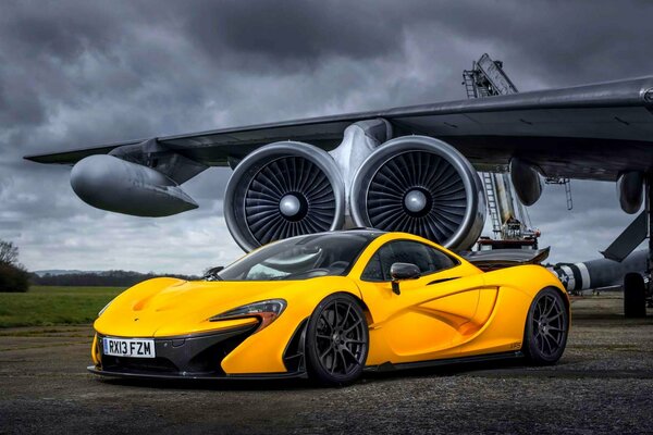 McLaren supercar yellow on the background of the plane