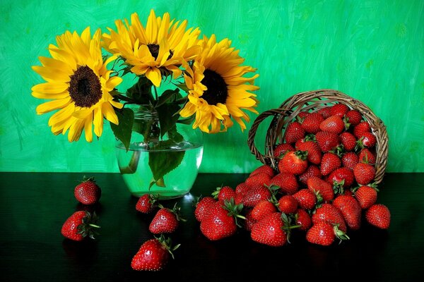 Natura morta di fragole in un cesto e fiori di girasole