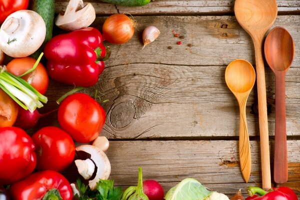 Assorted vegetables and a few wooden spoons