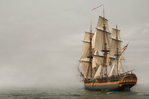 American sailboat at sea during fog