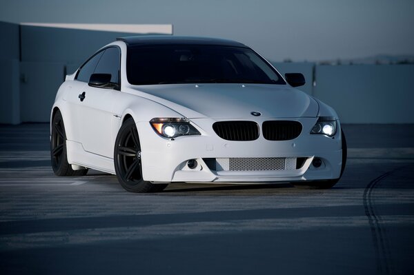 Front view of a white car in the parking lot