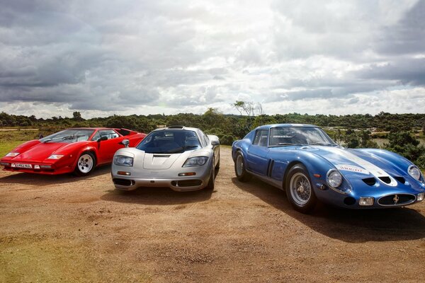 Lambargini, McLaren and Ferrari on the background of an amazing sky