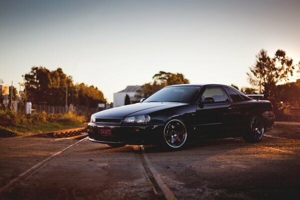 Black Nissan and the setting sun