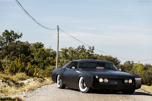 A black car on a deserted road