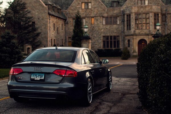 Black Audi car on the background of an old house